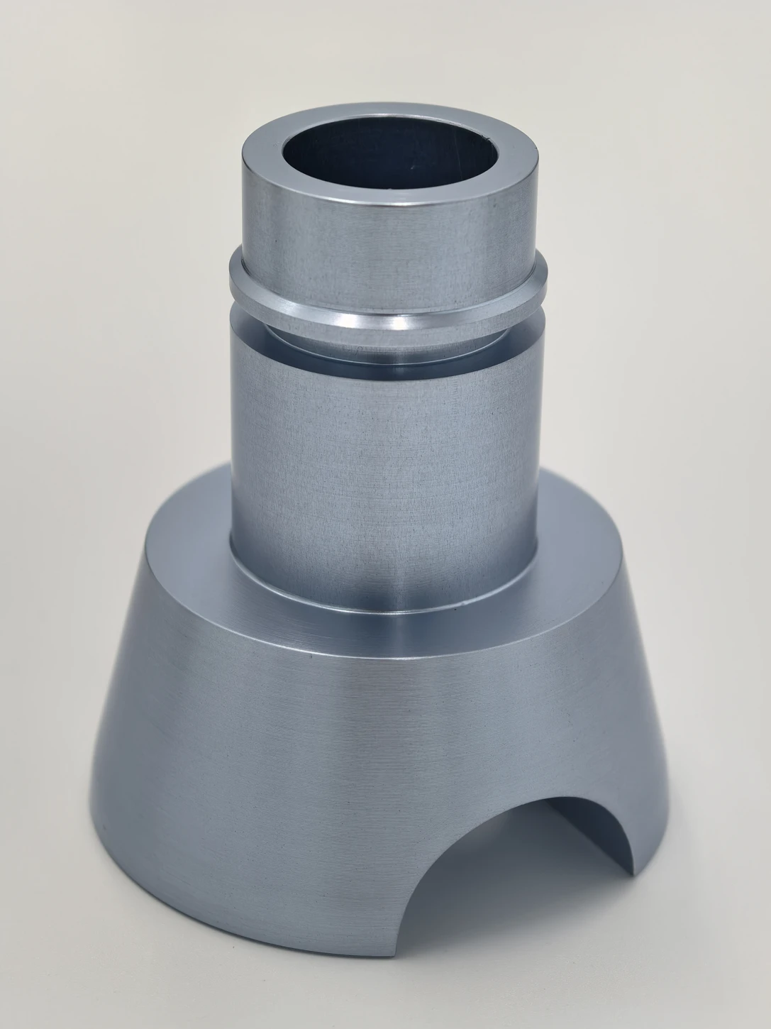 Blue-grey turned part with a cylindrical bore and profiled exterior