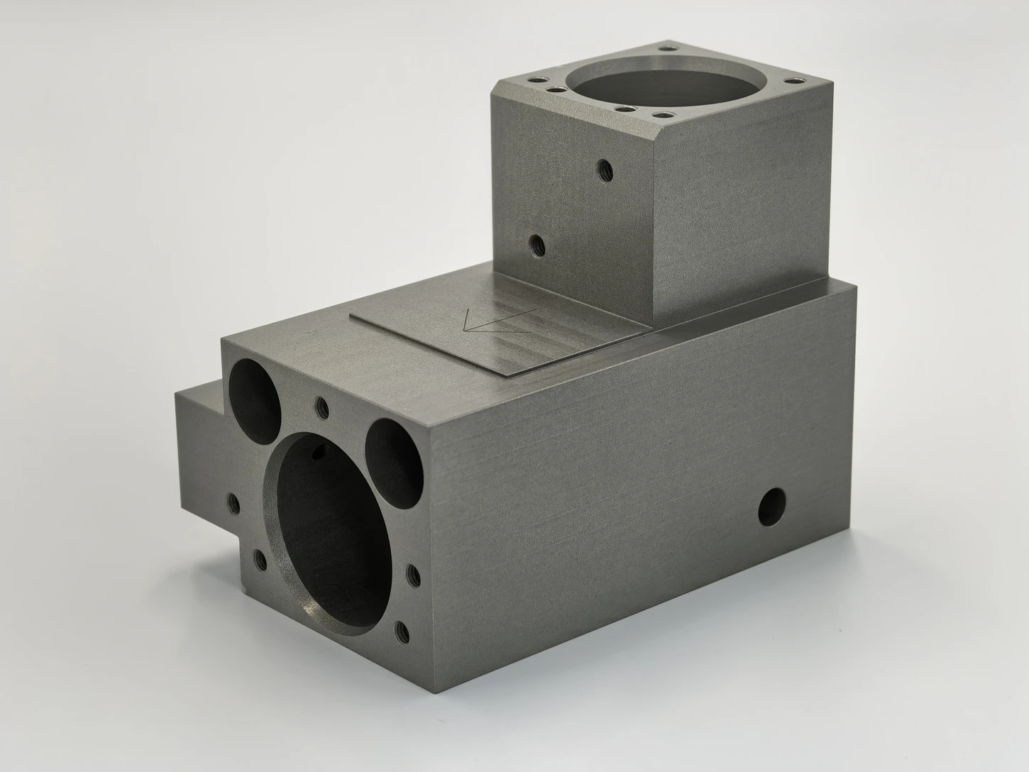 Turn-mill part with intersecting bores and machined mounting faces