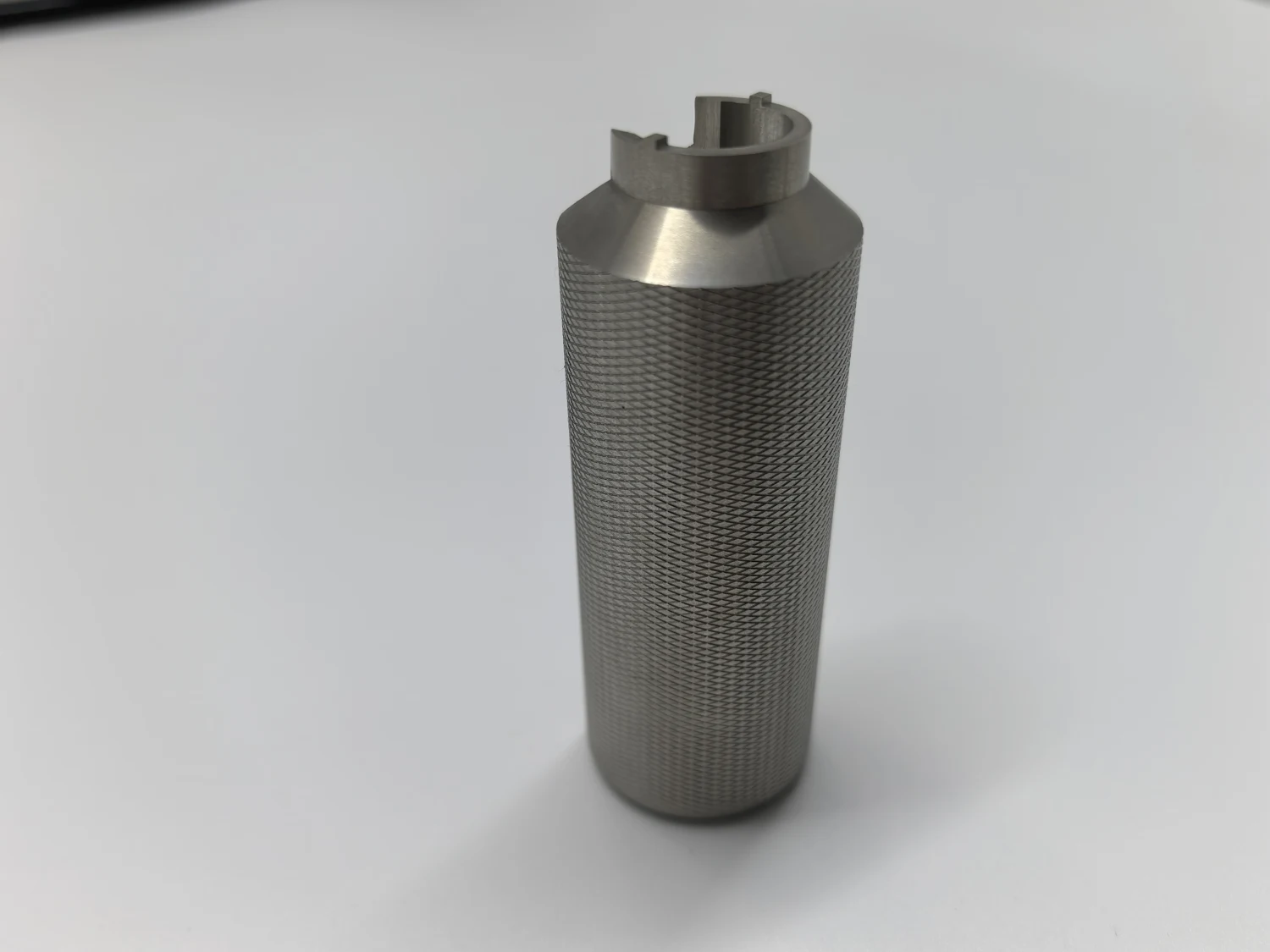 Close-up of a cylindrical component with a fine diamond knurled grip surface