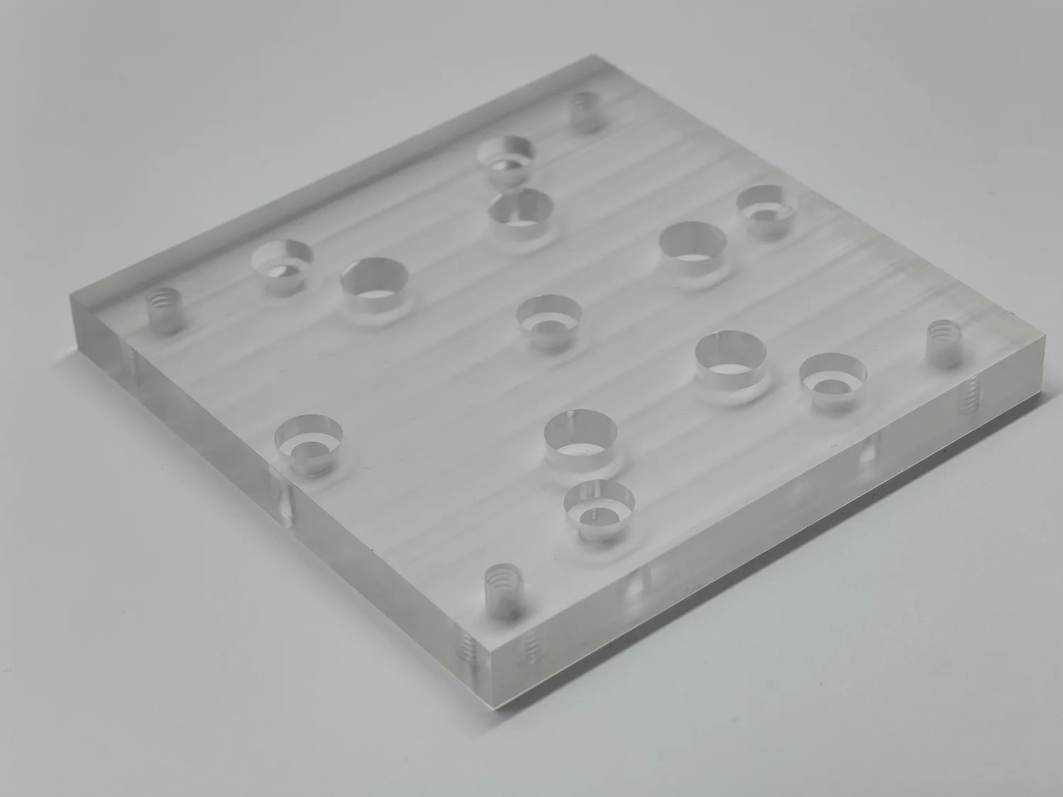 Clear component with drilled and counterbored features