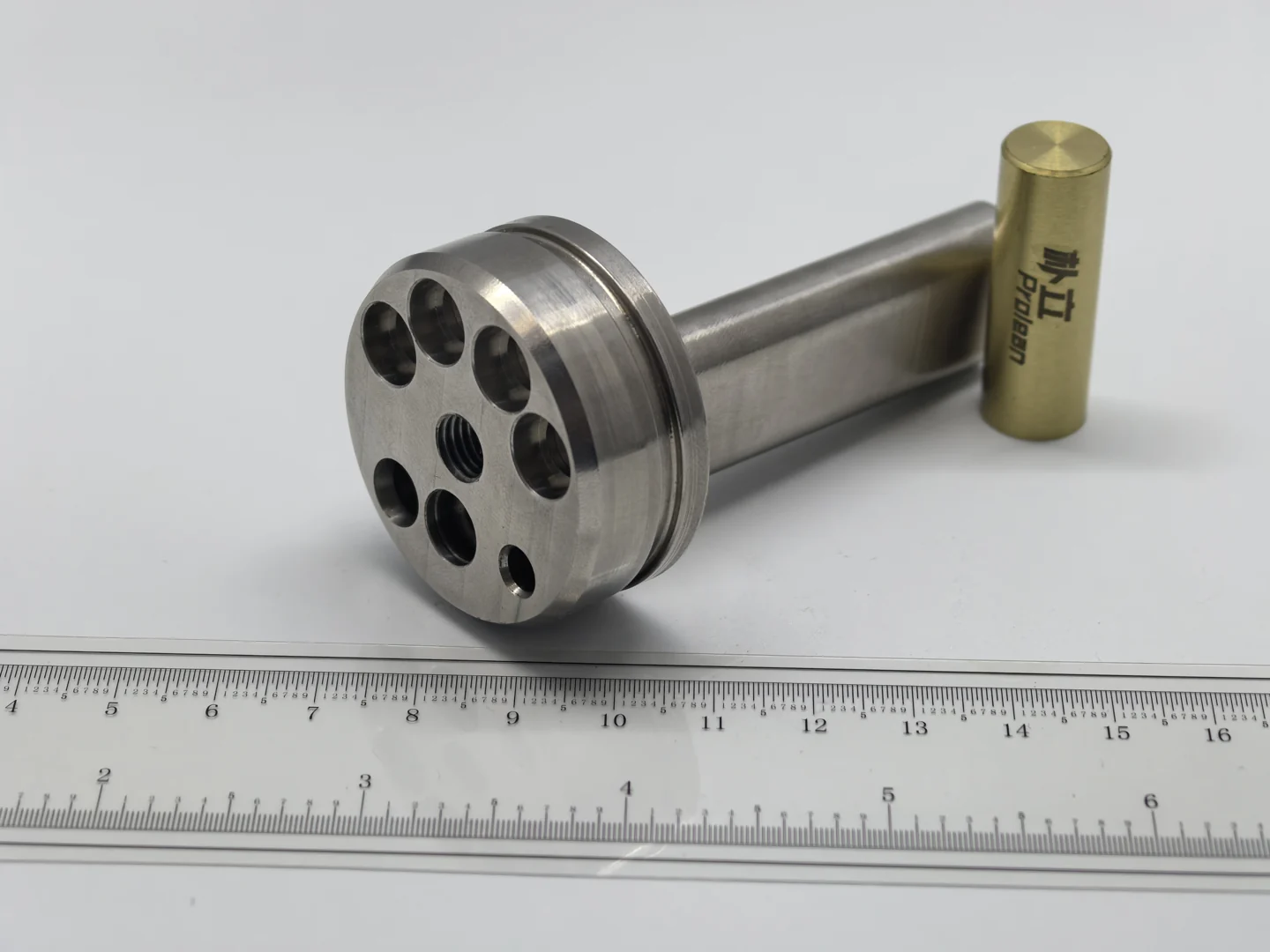 Stainless-labelled perforated cylindrical component in a local parts gallery photograph