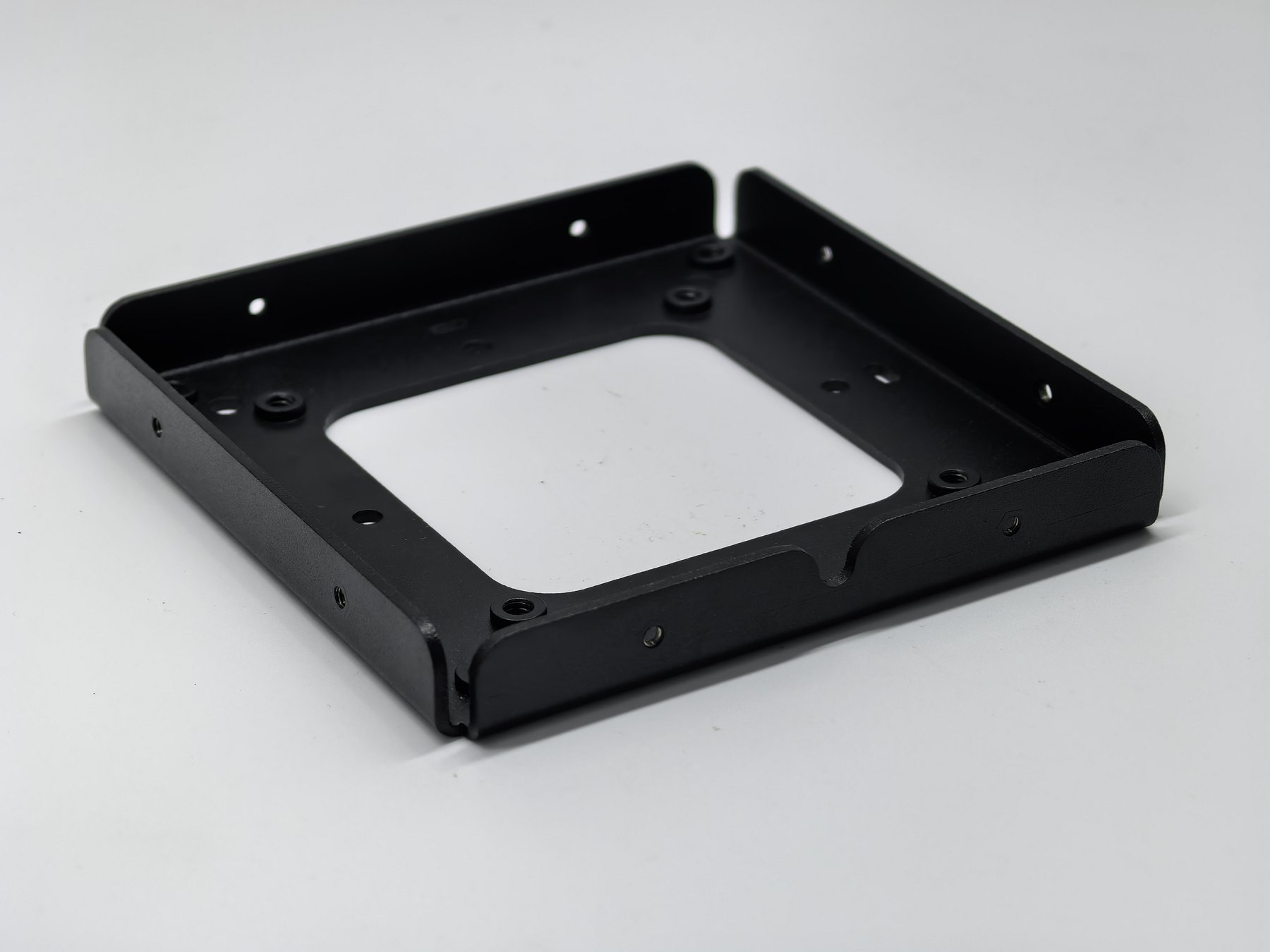 Black finished sheet metal frame with bent walls and installed threaded hardware