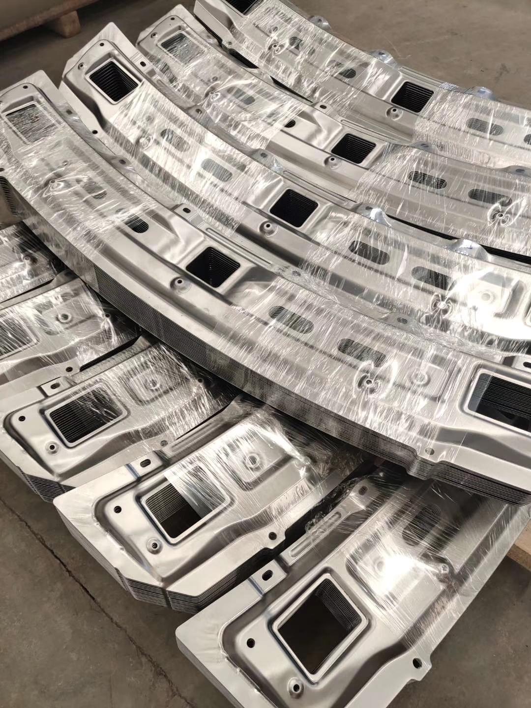 Stacks of repeated stamped sheet metal panels protected for handling