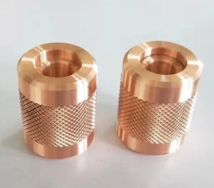 Two machined cylindrical sleeves with internal bores and textured exterior bands